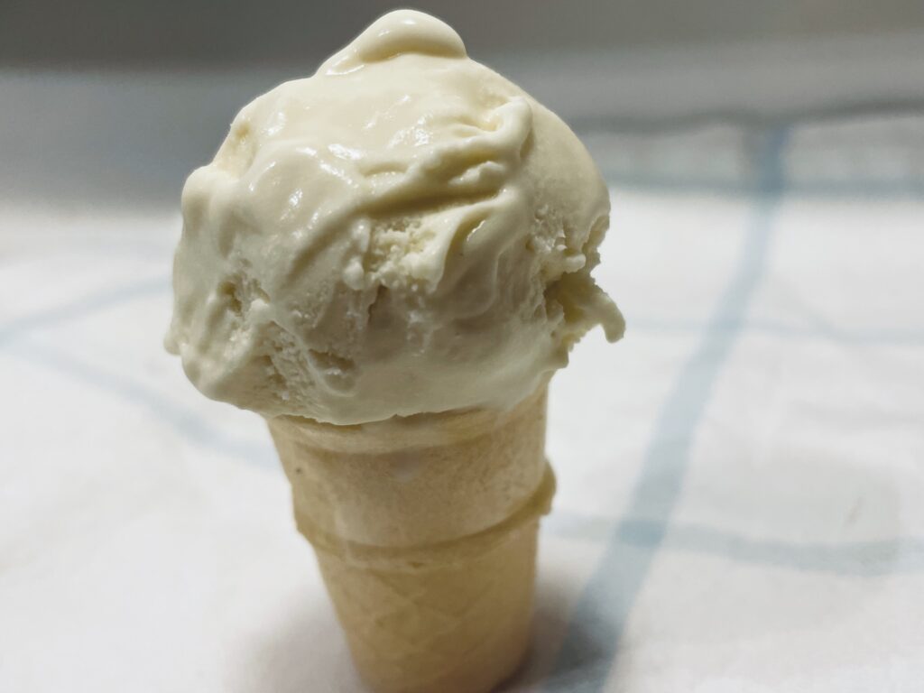 Kefir ice cream cone on white with blue strip towel