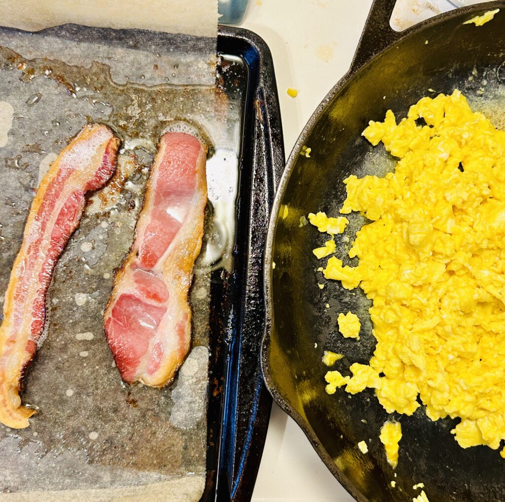 bacon on cookie sheet eggs in cast iron pan