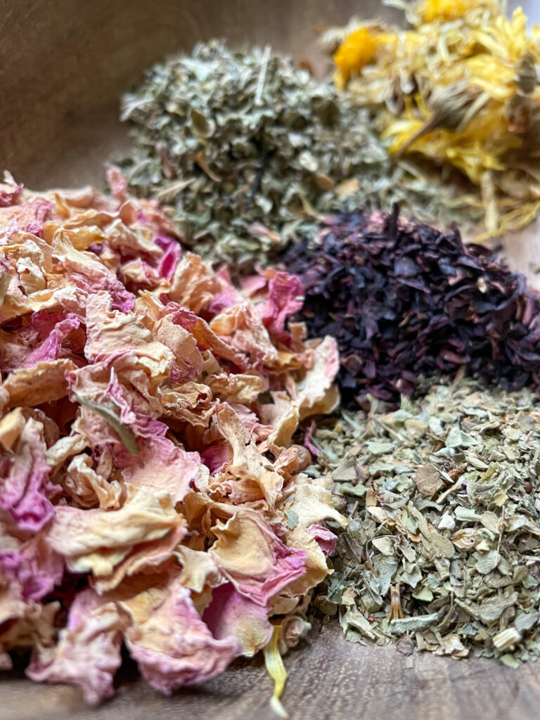 Dried yoni steam herbs in wooden bowl