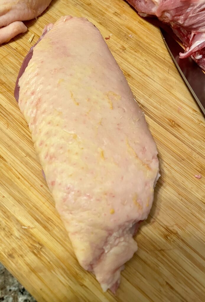 Rawduck breast on cutting board skin side up