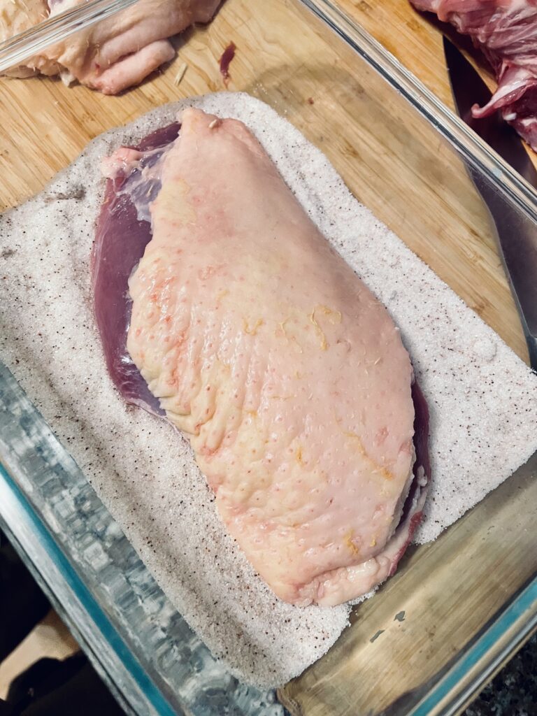 Raw duck breast on bed of salt