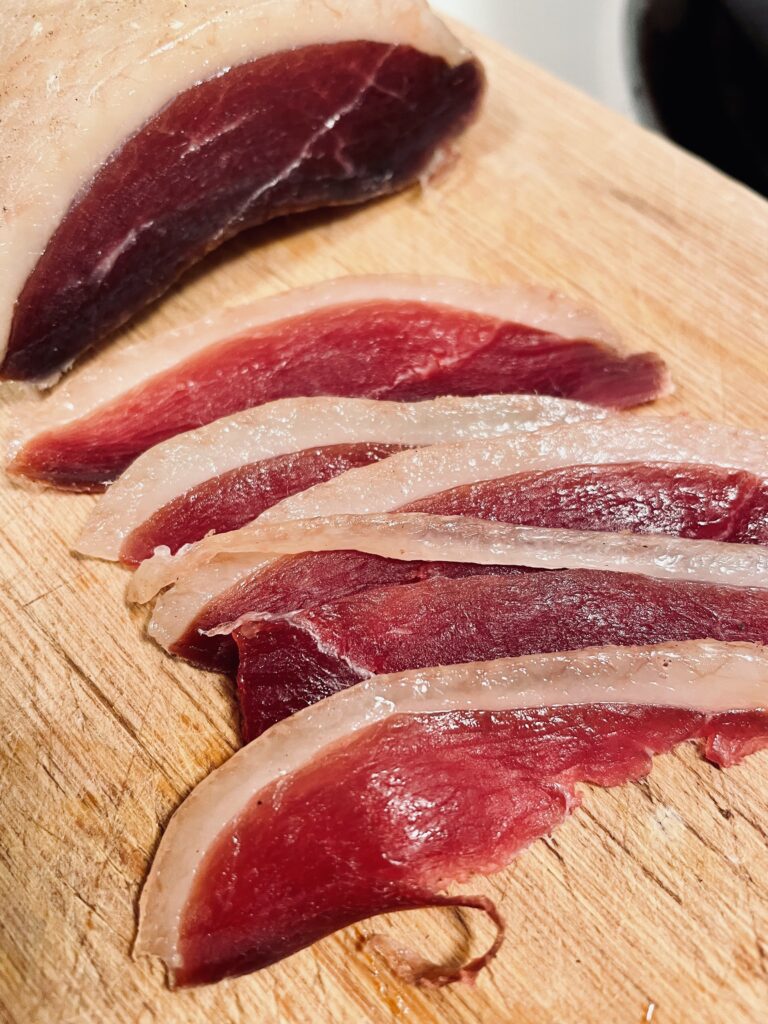 Sliced Duck Prosciutto on cutting board